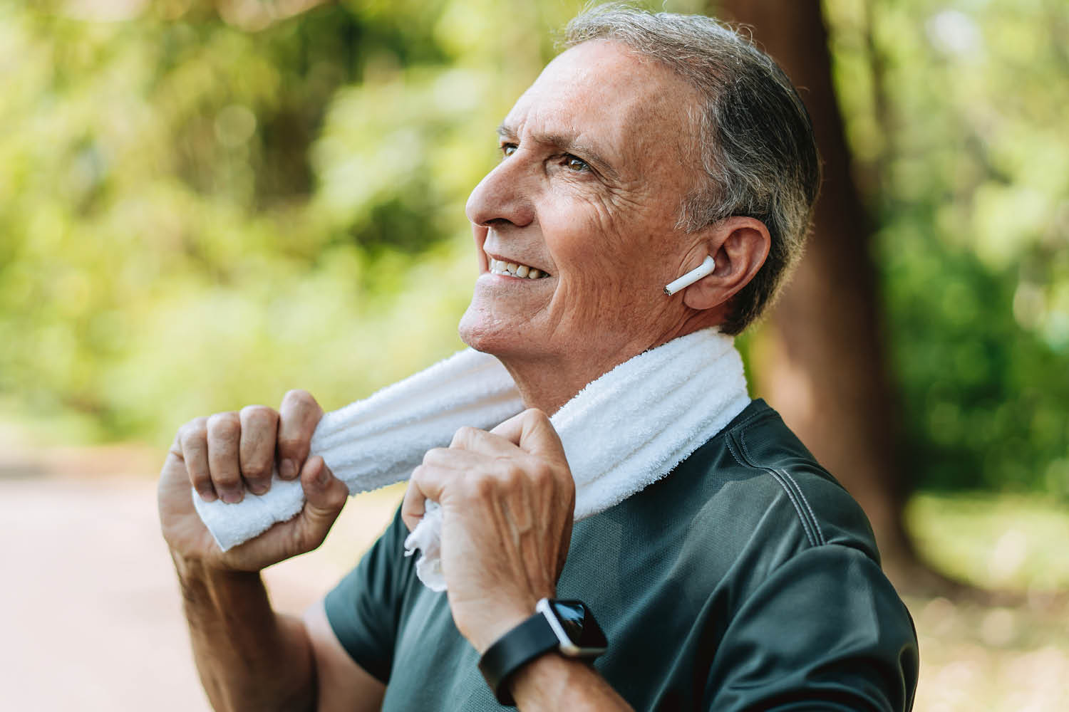 Older man cooling down with towel after outdoor activities