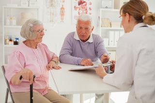 Doctor speaking to senior couple about a health directive