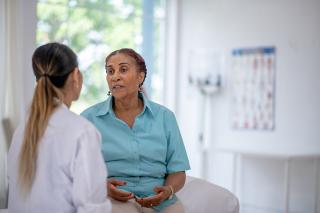 Patient speaking with doctor at routine visit 