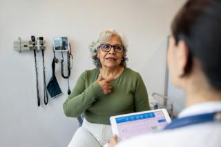 Patient speaking with her doctor about health numbers